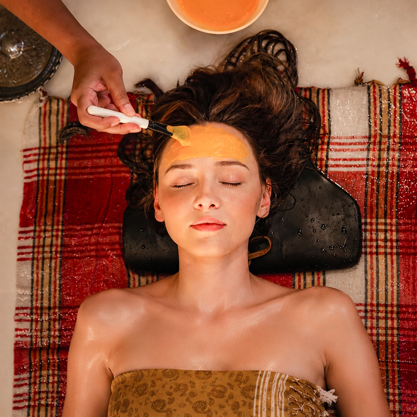 Natural face mask being applied during a hammam treatment